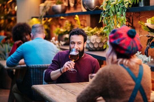 Friends socializing and enjoying drinks at a cozy bar
