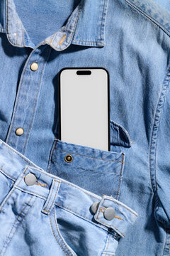Smartphone in a denim shirt pocket with denim shorts