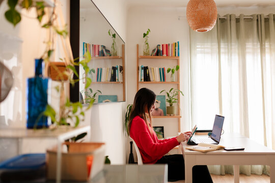 Woman Teleworking at Sunlit Home Desk