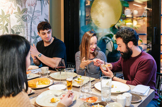 Friends enjoying dinner and drinks at a bar restaurant