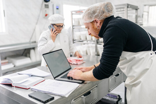 Artisan cheesemakers managing business logistics