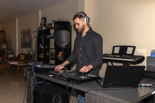 Bearded man dj mixing music at home party