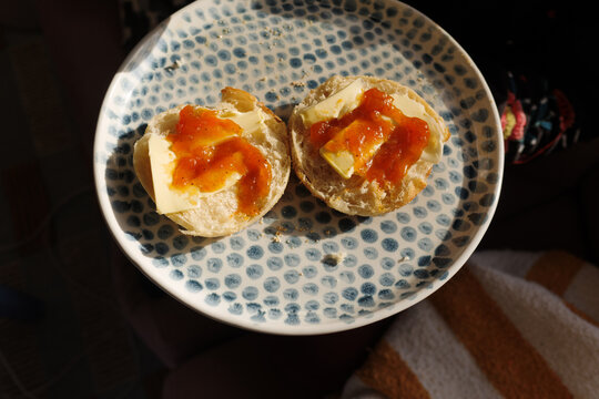 English muffin with butter and jam