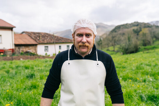 Artisan cheesemaker man working in rural small factory