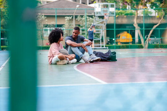 Basketball court conversation, father and daughter bonding time.