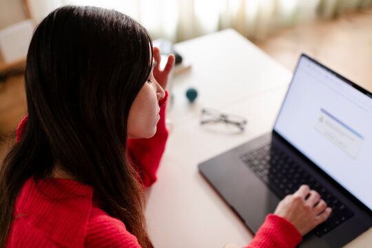 Stressed woman with malfunctioning laptop issues