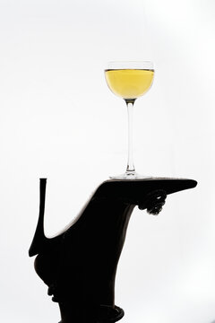 Cocktail glass balanced on elegant high heel silhouette