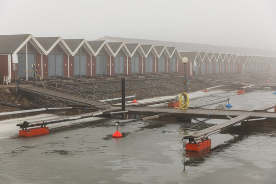 Empty Boat Slips and Floating Pontoons in Misty Marina