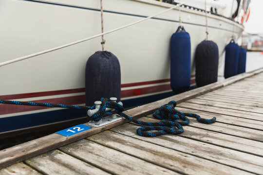 Close Up of Mooring Fenders and Ropes on Wooden Pier