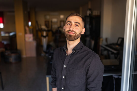 Portrait of a young man with a beard at home