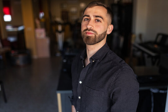 Portrait of a young man with a beard at home