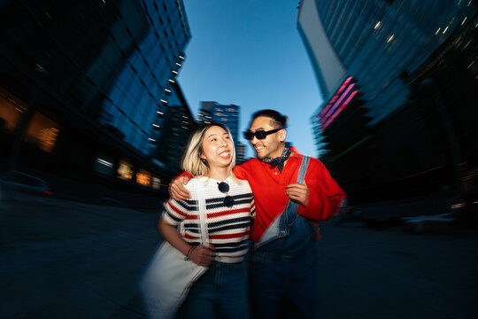 Young couple enjoying fun night out in city
