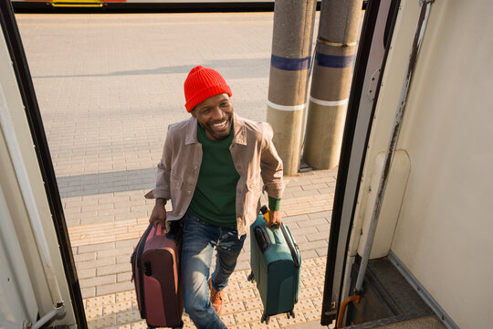 Smiling Man With Suitcases Enters The Train 
