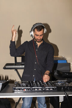 Bearded man dj mixing music at home party