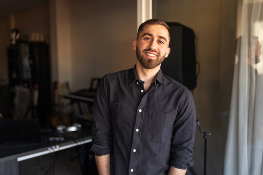 Portrait of a young man with a beard at home