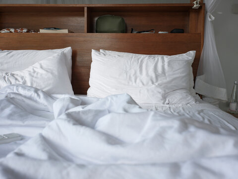 Bed With Rumpled Sheets and Pillows