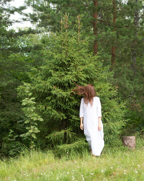 Woman in white near the tree