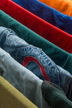 Colorful folded shirts with denim detail