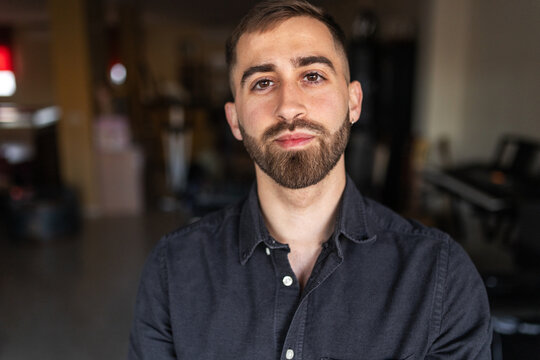 Portrait of a young man with a beard at home