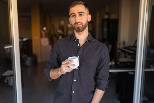 Portrait of a young man with a beard at home