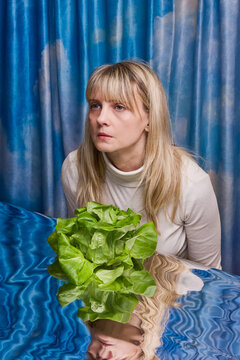 Woman and Butter Lettuce in front of blue sky curtains