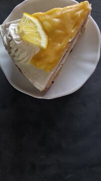 Top Down Video of Lemon Blueberry Cake with Whipped Cream Frosting and Lemon Slice Garnish Spinning Around with Copy Space