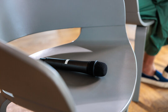 Microphone rests on a modern gray chair.