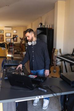 Dj mixing music at home studio with headphones