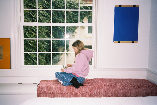 Girl Portrait in room working on Ipad tablet computer 
