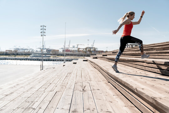 Runner Sprinting On Wooden Bleachers