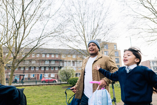 Father picking up children from school after classes