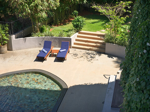 Relaxation Area With Lounge Chairs and Pool in a Private Garden