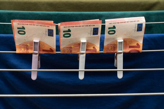 Euro banknotes clipped on drying rack in row