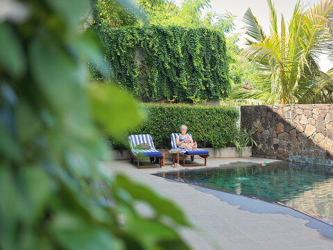 Person Relaxing by the Pool at Luxury Hotel