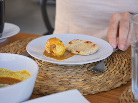 Traditional Sri Lankan breakfast of Egg Curry with Flatbread 