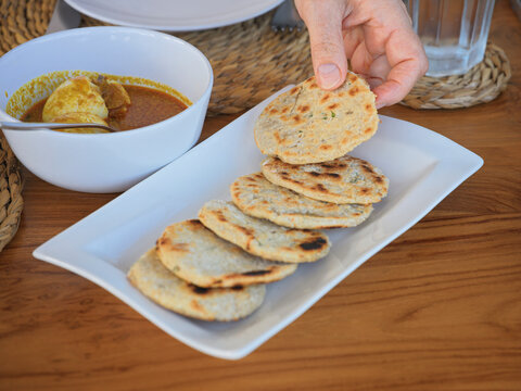 Freshly Made Flatbreads Served With Egg Curry in a Restaurant