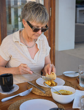 Woman Enjoys Breakfast at Hotel Restaurant