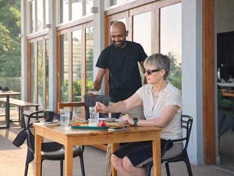 Server Brings Food to Woman at a Hotel in the Morning
