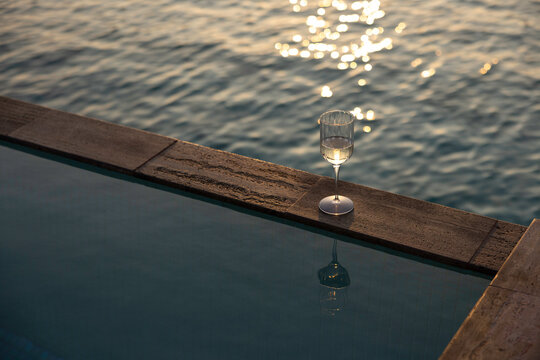 Glass of wine on a Maldives overwater villa pool edge 
