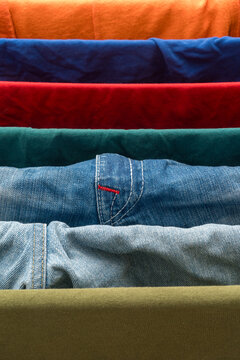Colorful layered fabrics and denim textures in horizontal arrangement