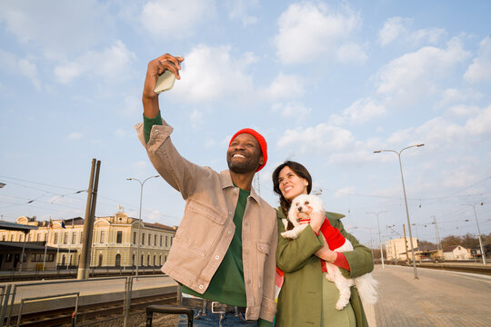 People Take Selfie With Dog at Train Station 
