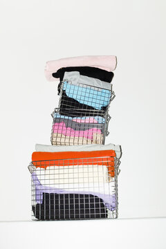 Silver wire baskets full of colourful fabrics and clothes with flash