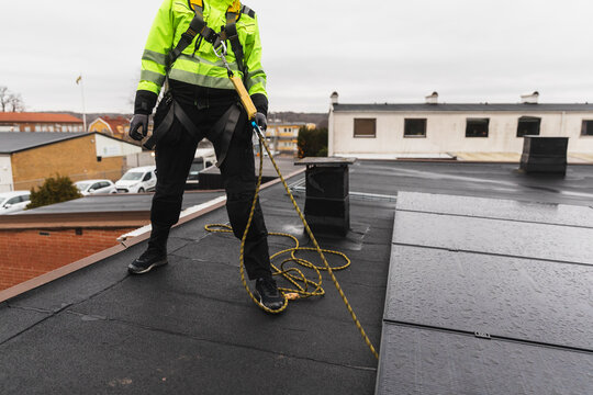 Female Solar Technician Wearing Full Body Safety Harness
