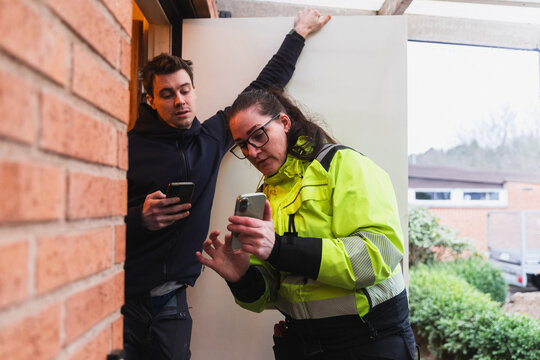Technician and Homeowner Compare Energy Inspection Results via phone