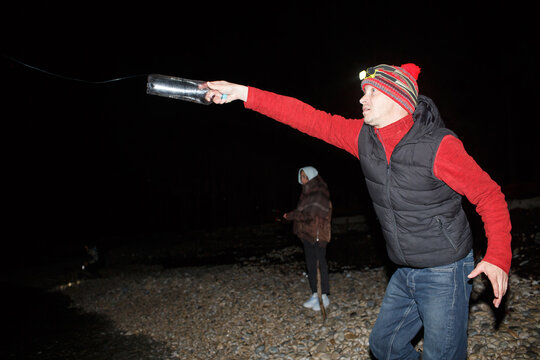 Fisherman uses a homemade fishing tackle  at night
