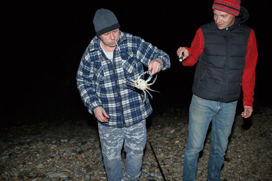 Fishermen and a blue crab