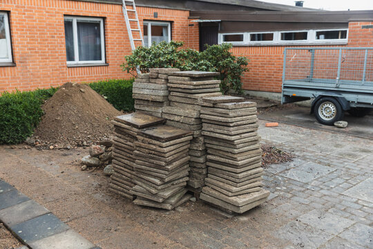 Stacked Paving Stones and Utility Trailer at Residential Worksite