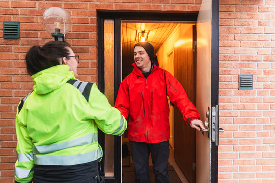 Technician Greeting Homeowner at Entrance for Service Appointment