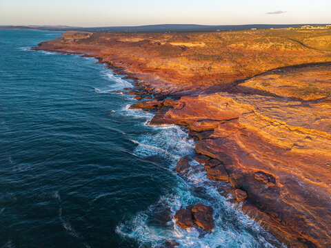 Aerial view of the Kalbarri cliffs lit up at sunset.