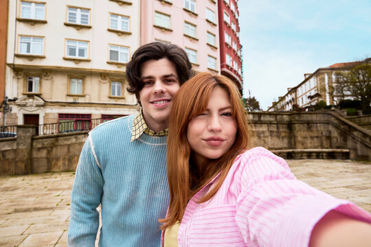 Couple taking selfie in historic European city square